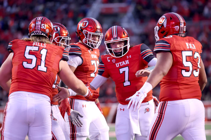 Utah Utes quarterback Cameron Rising (7) celebrates a touchdown with the offensive line in a game against the Arizona Wildcats during the second quarter at Rice-Eccles Stadium.